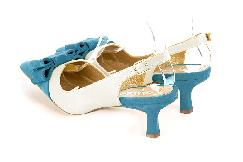 Women's peacock blue and off white elegant slingback heels, with a bow on the front. Tapered toe. Medium spool heels - Rear view